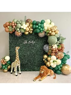 a giraffe and a lion are sitting in front of a fake grass backdrop