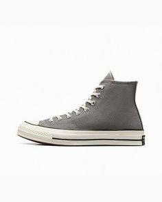 Elevate your sneaker game with these Converse Chuck 70 Hi Vintage Canvas Origin Story sneakers in gray. These high top sneakers feature a lace-up closure and a solid pattern with star and sports themes. The upper material is made of canvas, while the outsole material is rubber. The shoe width is D, and the size is 11 for both the UK and US, and 45 for EU. The shoes are perfect for walking and basketball, with features such as cushioning, comfort, and breathability. The lining material is also ma Origin Story, Converse Chuck 70, Sneaker Games, Chuck 70, Vintage Canvas, Solid Pattern, Converse Chuck, Chucks Converse, High Top