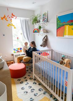 a child sitting in a crib reading a book