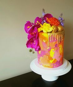 there is a colorful cake with flowers on it