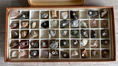 an open box filled with rocks on top of a wooden table