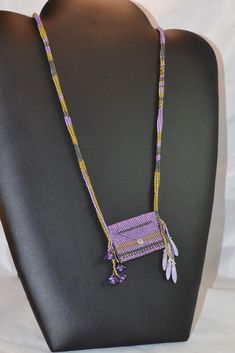 This little amulet purse necklace is designed to allow you to add a note, an affirmation, or any other special memento. A perfect gift for that special someone, it will come to you in a gift box. Designed and beaded in my Las Vegas studio, this pendant necklace is all Delica beads, and is designed to slip over your head. For more of my handmade jewelry and accessories, please visit Cloe'sCloset at: www.etsy.com/shop/CloesCloset?section_id=10064153 Colorful Beaded Amulet Style Jewelry, Multicolor Amulet Beaded Necklace, Multicolor Beaded Amulet Necklaces, Purple Amulet Necklace, Purse Necklace, Beaded Amulet Bags, Amulet Bag, Shades Of Lavender, Bag Necklace