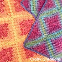 two crocheted dishcloths sitting next to each other on top of a table