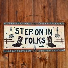 a sign that says step on in folks hanging on a wooden wall with wood planks