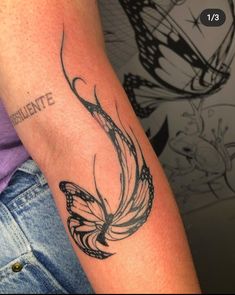 a woman's arm with a butterfly tattoo on the left side of her arm