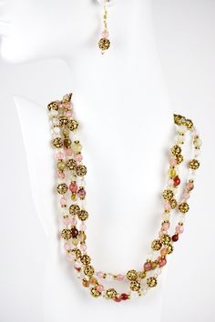 Style and luxury are embodied in this lovely and fashionable three strand round cherry quartz beads necklace. Gold Bali bead and rondelles, with Swarovski© crystals are adorned with an adjustable gold chain and lobster claw clasp Let loose in the evening with a cocktail dress or classic cocktail wear. Let it sparkle under warm candlelight. After all, you're worth it. Elegant Faceted Beads Crystal Necklace For Party, Elegant Faceted Bead Crystal Necklaces For Party, Elegant Multi-strand Beaded Crystal Necklace, Elegant Multi-strand Beaded Crystal Necklaces, Elegant Beaded Multi-strand Crystal Necklace, Elegant Beaded Multi-strand Crystal Necklaces, Elegant Multi-strand Gold Beaded Necklaces, Elegant Double Strand Crystal Necklace With Faceted Beads, Elegant Multi-strand Crystal Necklace With Polished Beads