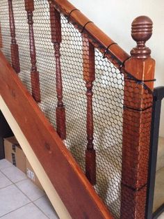 a wooden banister next to a tiled floor