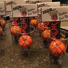 orange basketballs are in small baskets on the counter