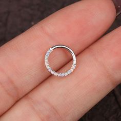 a close up of a person's finger with a ring on it