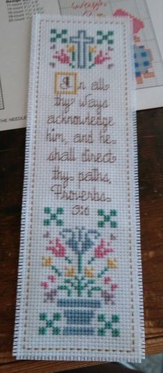 a cross stitch bookmark with a bible verse