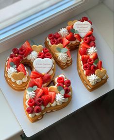 heart shaped cookies decorated with strawberries and other toppings