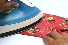 a person ironing fabric with an iron