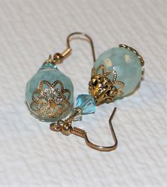 The earrings are composed of czech glass beads, swarovski crystals and antiqued filgree accents and gold ear wires. I am a SARJD #3614, (self-representing artist in jewelry design) and all of my designs are OOAK, (one of a kind). All items will be packaged in a box for jewelry and wrapped in bubble wrap then a bubble mailer for extra security. Shipping is next day after payment is received. If you have any questions please contact me before you buy. Box For Jewelry, Antique Filigree, Jewelry Design Inspiration, Glass Beads Jewelry, Craft Jewelry, Filigree Earrings, Earrings Flower, Earring Tutorial, Earrings Crystal