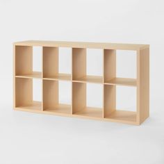 a wooden shelf with six compartments on the top and one section open to reveal an empty space