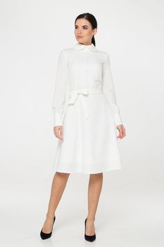 "A collared midi dress featuring a button front closure (imitation), fabric belt, and a fit and flare silhouette. - fit and flare silhouette - high rounded collar - knee length (midi) - long sleeves with cuffs - fabric belt - covered button front decor - concealed zipper closure - lined bodice and skirt - color: white Fiber: 60% viscose, 35% polyester, 5 % elastane, Lining - 95 % viscose, 5% elastane. For size S:dress length- 40,0 \" (102 cm), sleeve length 24,21\" (61,5 cm) Our model wears size Chic A-line Dress With Button Cuffs, Fitted Long Sleeve Dresses With Belted Cuffs, Classic White A-line Shirt Dress, Elegant Long Sleeve Belted Shirt Dress, Feminine Embroidered Midi Dress For Wedding, Chic Mid-length Wedding Dress, Elegant Collared Midi Dress For Daywear, Classic Long Sleeve Dress For Dress Down, Elegant Shirt Dress With Button Cuffs For Casual Wear