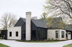 a black and white house with stone chimney