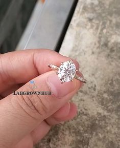 a person holding a diamond ring in their hand