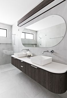 a bathroom with two sinks and a large mirror