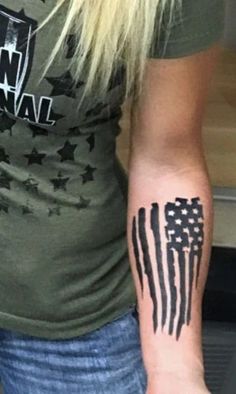 an american flag tattoo on the arm of a woman's left hand and wrist