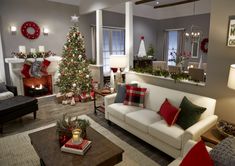 a living room filled with furniture and a christmas tree