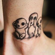 a tattoo on the neck of a person with three little koalas in it