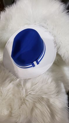 Blue and White, She's Out of Sight Walk into any space with this lovely blue and white classic fedora and watch the heads turn. This fedora fits a medium dome super comfy.  Wearing big hair?  That's fine!  You can wear this statement piece tilted back or shouldered to the side.  The fedora measures 57cm or 22.44 inches. Blue Summer Hats For Day Out, Blue Wide-brim Hat For Day Out, Blue Summer Hat For Day Out, Blue Wide Brim Hat For Day Out, Blue Summer Hats For A Day Out, Blue Hats For Summer Day Out, White Fitted Summer Fedora, Fitted White Summer Fedora, Blue Curved Brim Fedora For Vacation