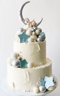 a three tiered cake with stars and moon decorations