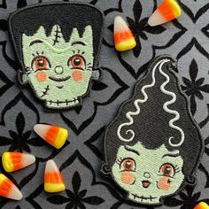 two halloween patches with candy on them and one has a witch's head in the middle