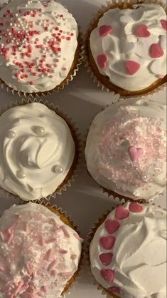 six cupcakes with white frosting and pink sprinkles