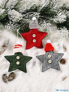 three knitted stars hanging from a christmas tree