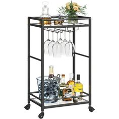 a metal bar cart with wine glasses and liquor bottles