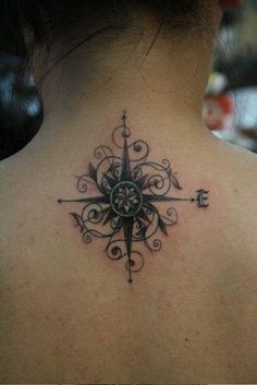 a woman with a compass tattoo on her back