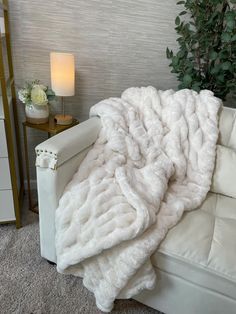 a white couch with a blanket on it