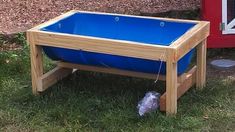 a large blue water tank sitting in the grass