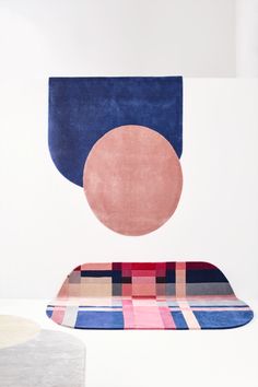 the rug is on the floor and next to it is a table with a round shaped object