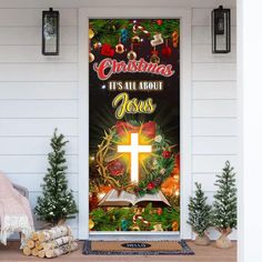 a christmas door cover with an open book and cross on it, surrounded by evergreens