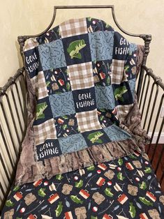 there is a bed with a quilt on it that says gone fishing and an alligator