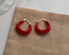 Add some whimsy to your look with these enamel chunky hoops. Perfect for daily wear and plated with 14k gold vermeil, these wavy hoop earrings come in a playful array of white, green, red, black, and brown. About 23mm in diameter, they're dainty yet elegant, making them the perfect accessory for any occasion. Trendy Red Hoop Earrings, Trendy Small Red Hoop Earrings, Trendy Small Hoop Red Earrings, Trendy Red Hoop Earrings For Everyday, Red Hoop Jewelry For Everyday, Everyday Red Hoop Jewelry, Modern Red Small Hoop Earrings, Modern Small Red Hoop Earrings, Red Enamel Hoop Earrings Gift