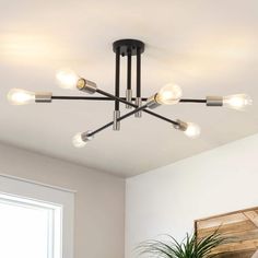 a light fixture in a room with a potted plant