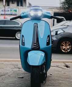 a blue scooter is parked on the street