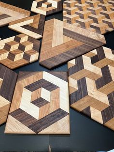 several pieces of wood sitting on top of a black table with white and brown designs