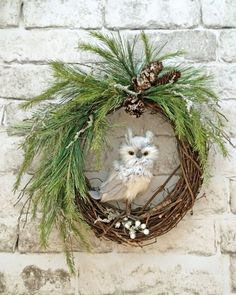 an owl in a wreath on a brick wall