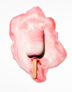 an ice cream lollypop with a wooden stick sticking out of it's center