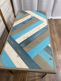 a wooden table with blue and white strips on it