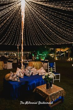 an outdoor tent with lights and decorations on it