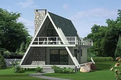 a - frame house in the middle of a lush green yard with stairs leading up to it