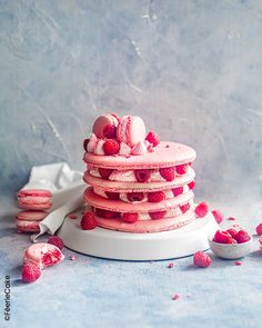 a stack of raspberry shortcakes sitting on top of a white plate