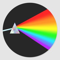 a rainbow triangle with a white light coming from it's center round sticker