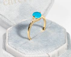 Material: 14k/18k goldColor Options: Yellow Gold, White Gold, Rose GoldCenter Stone: Natural Turquoise RoundSize: 6 mmApprox Weight (Ct): 0.98Accent Stones: Diamond RoundSize: 1.2 mm * 6 Nos. , 1.5mm * 2 Nos.Approx Weight (Ct): 0.065Ring Height: 6.5 mmBand Width: 1.5 mm Turquoise Opal Ring In 14k Gold, Turquoise Round Opal Ring In 14k Gold, Turquoise 14k Gold Round Opal Ring, 14k Gold Turquoise Round Ring, Yellow Gold Turquoise Ring With Gemstone Accents As Gift, 14k Gold Turquoise Ring, Yellow Gold Turquoise Birthstone Ring, Natural Gemstone Jewelry, 18k Gold Ring