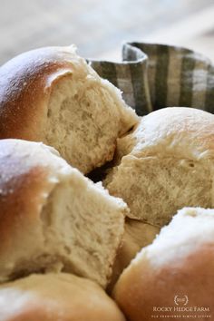 a basket filled with rolls sitting on top of a table